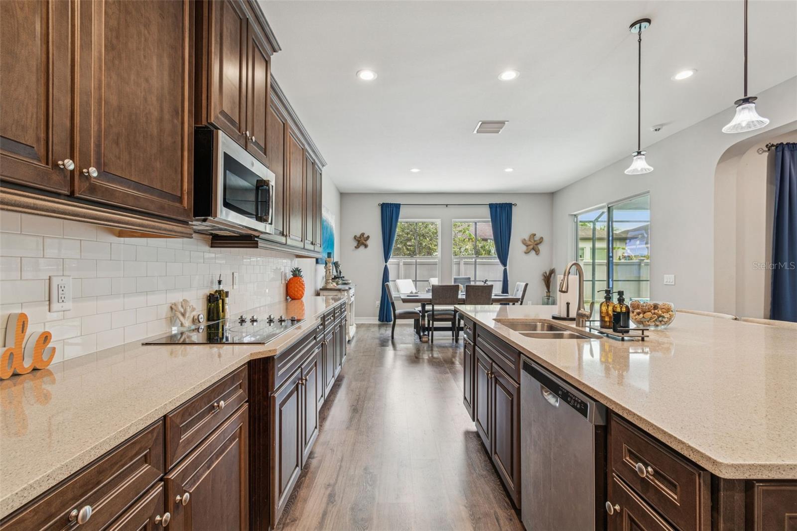 Kitchen featuring an oversized island, walk-in pantry, and ample cabinetry