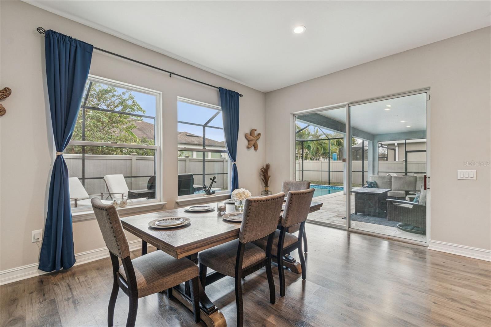 Dining area opening to the private pool and outdoor living space
