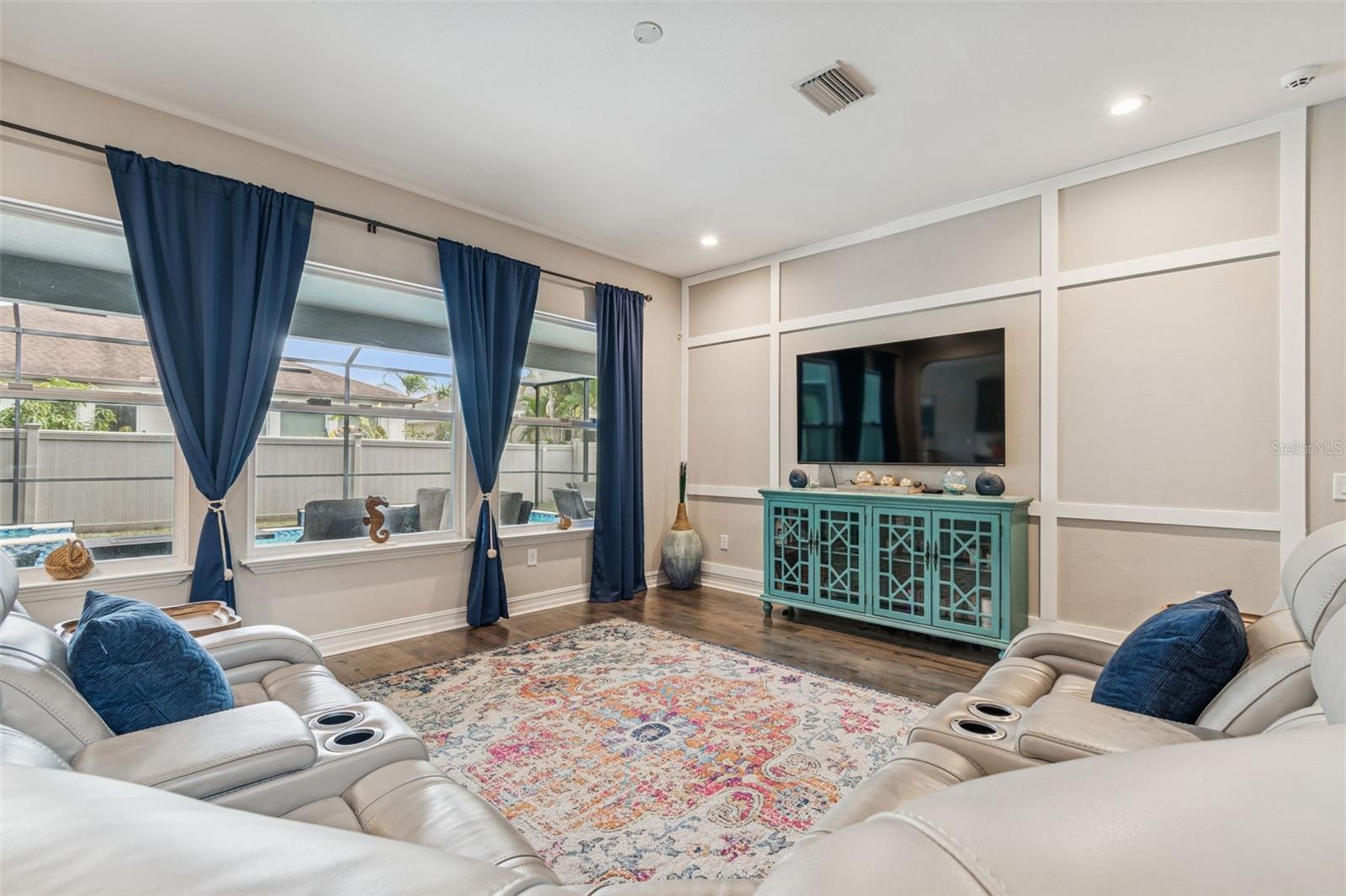 Open living area with view of the pool