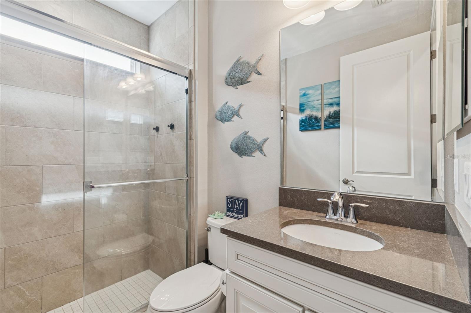 First-floor bathroom with walk-in shower just outside the guest bedroom