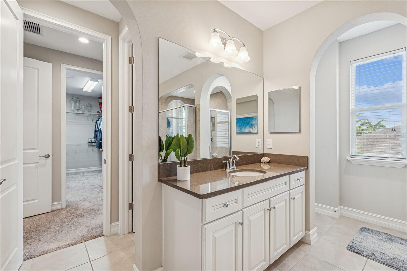 Spa-inspired primary en suite featuring a soaking tub, oversized shower, dual vanities, and generous storage
