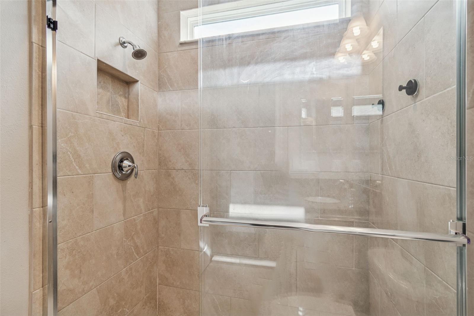 Spa-inspired primary en suite featuring a soaking tub, oversized shower, dual vanities, and generous storage