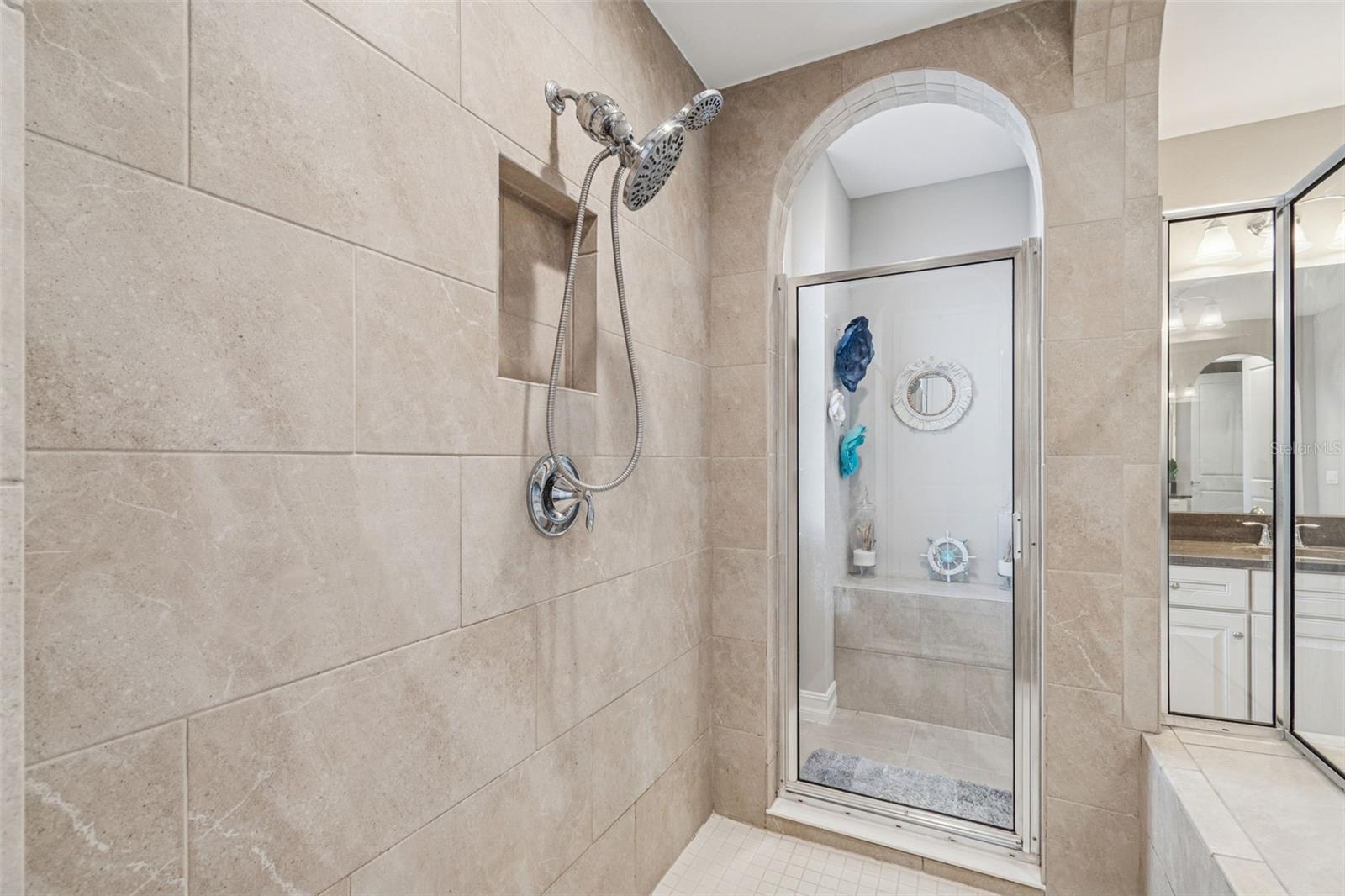 Spa-inspired primary en suite featuring a soaking tub, oversized shower, dual vanities, and generous storage