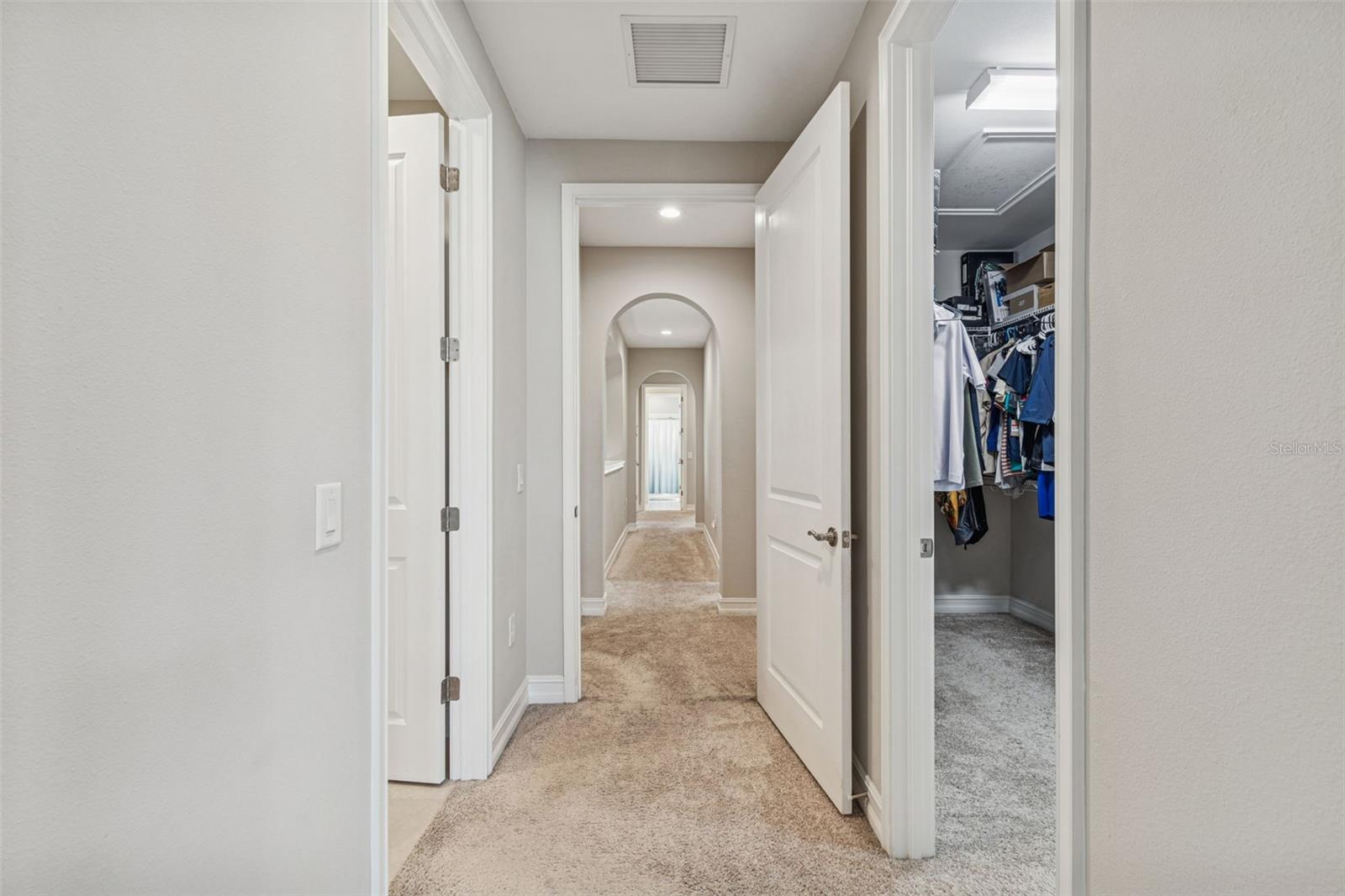View of the hallway from the primary bedroom and closet