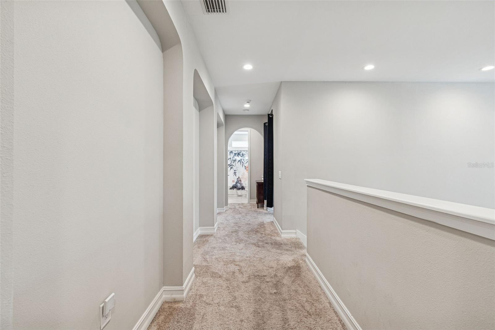 Hallway just outside the primary suite leading to the loft