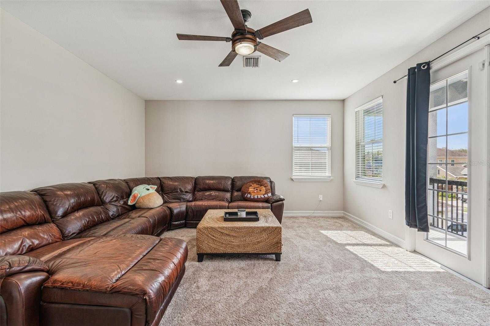 Upper-level loft with view of patio