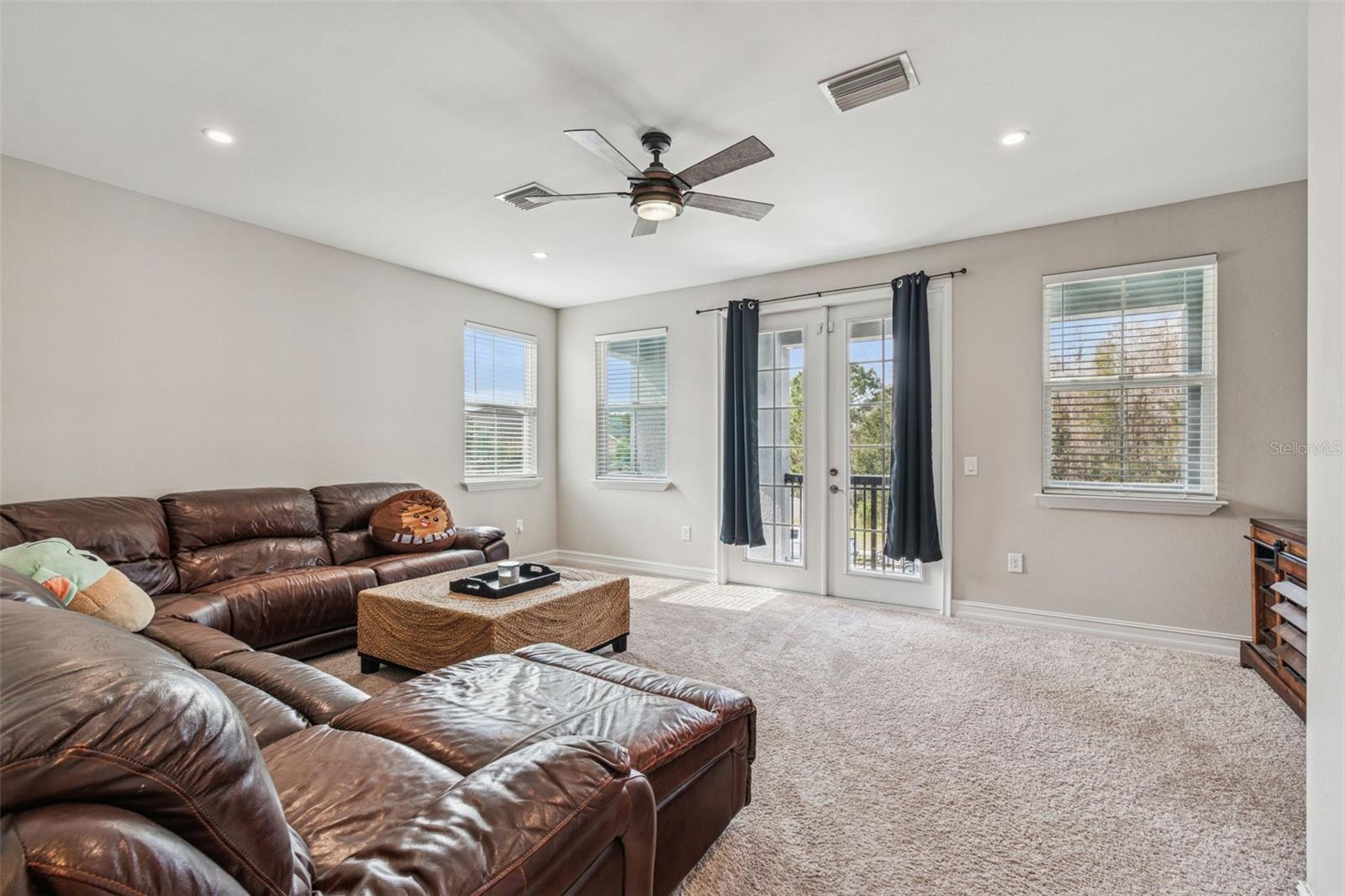 Upper-level loft with view of patio