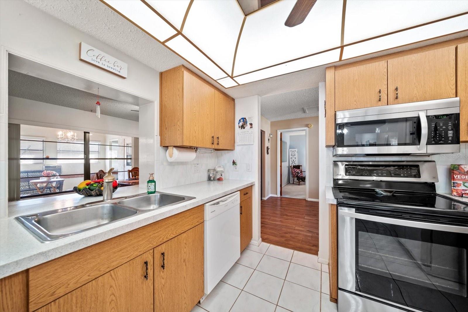 Kitchen overlooks dining area with a pass through window