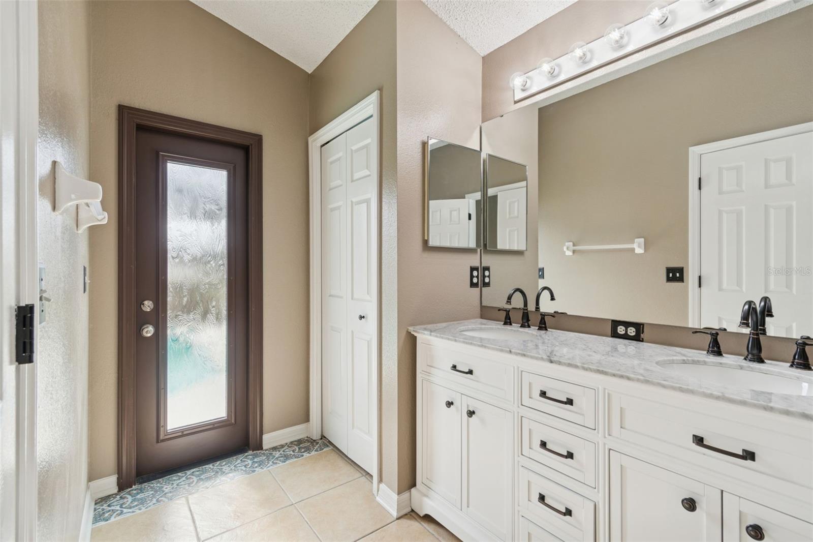Primary bath with side entry door to pool