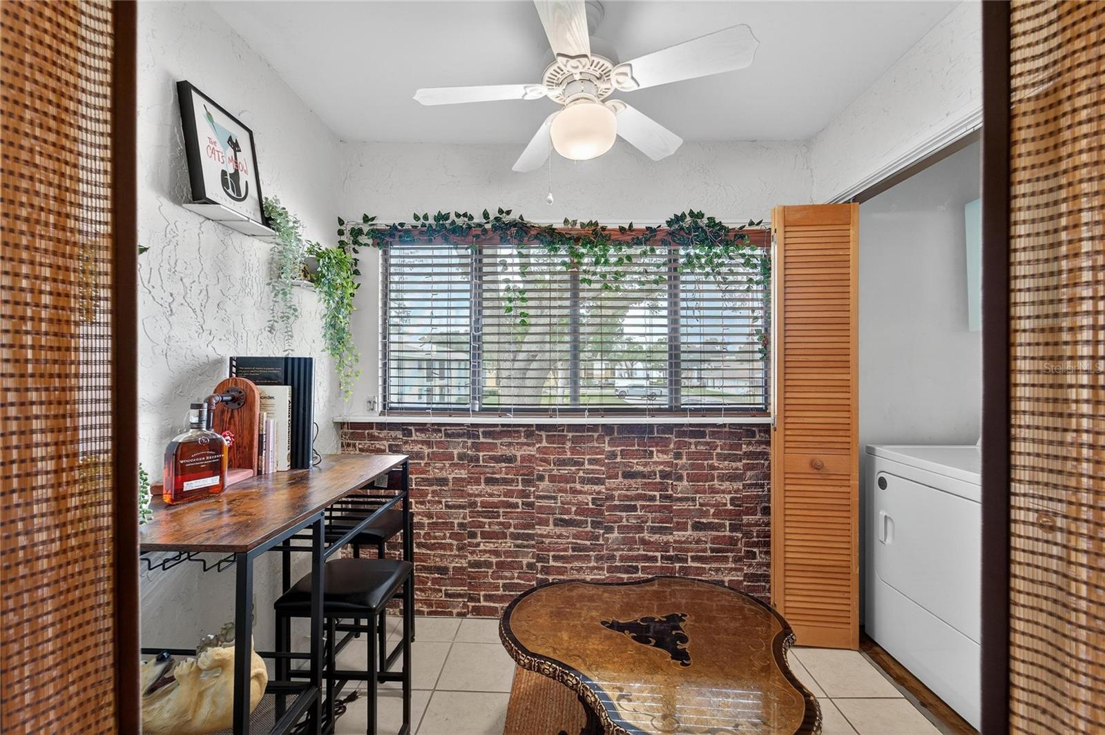 Your office/bar/workout space has been full enclosed, offering additional living space beyond a screened porch.