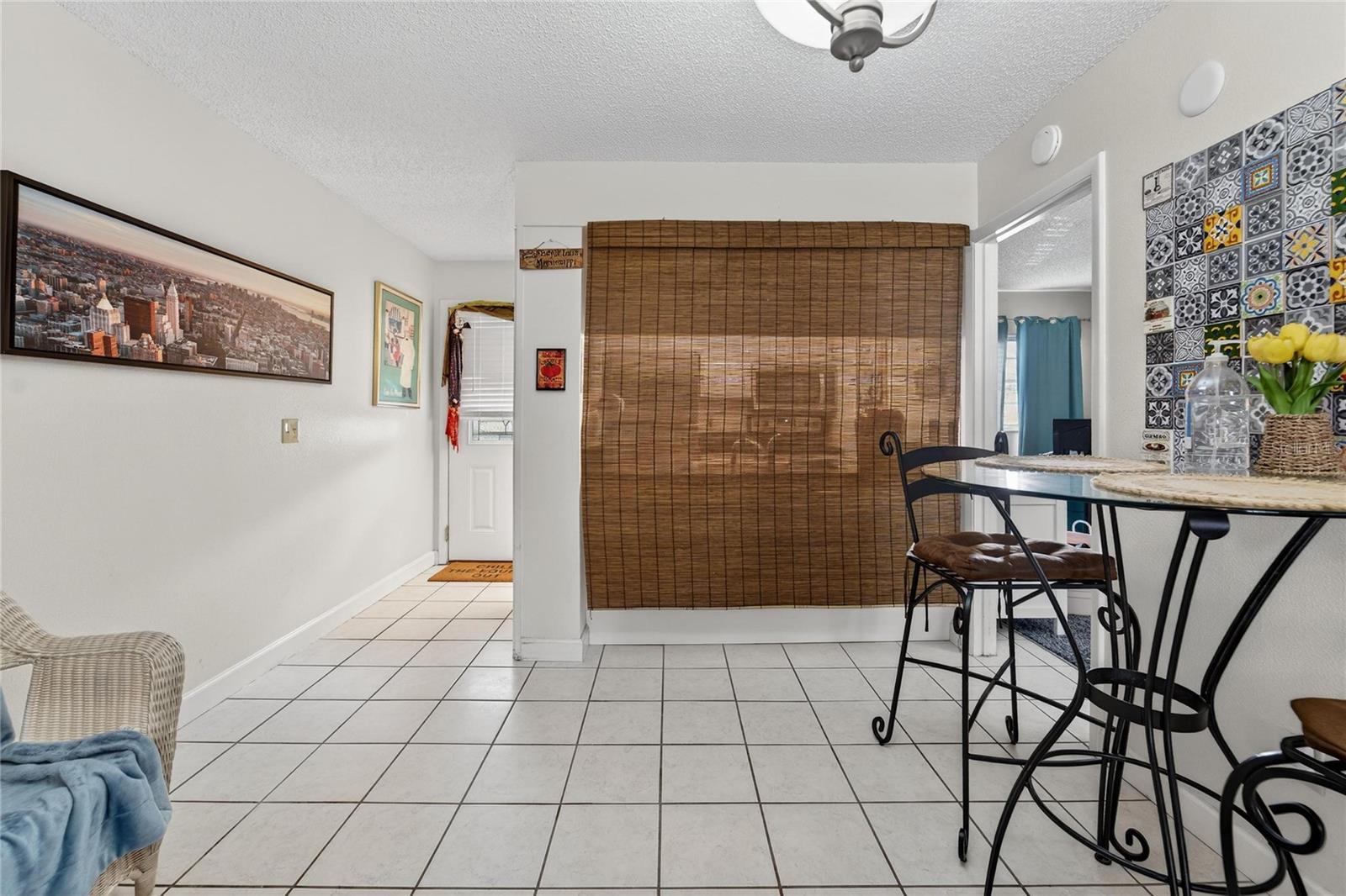 Dining Room area with bamboo shade separating bar seating area