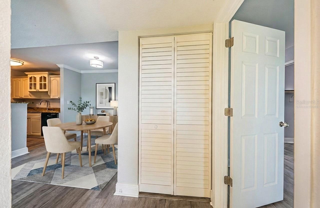 Entry way with virtually staged dining and kitchen