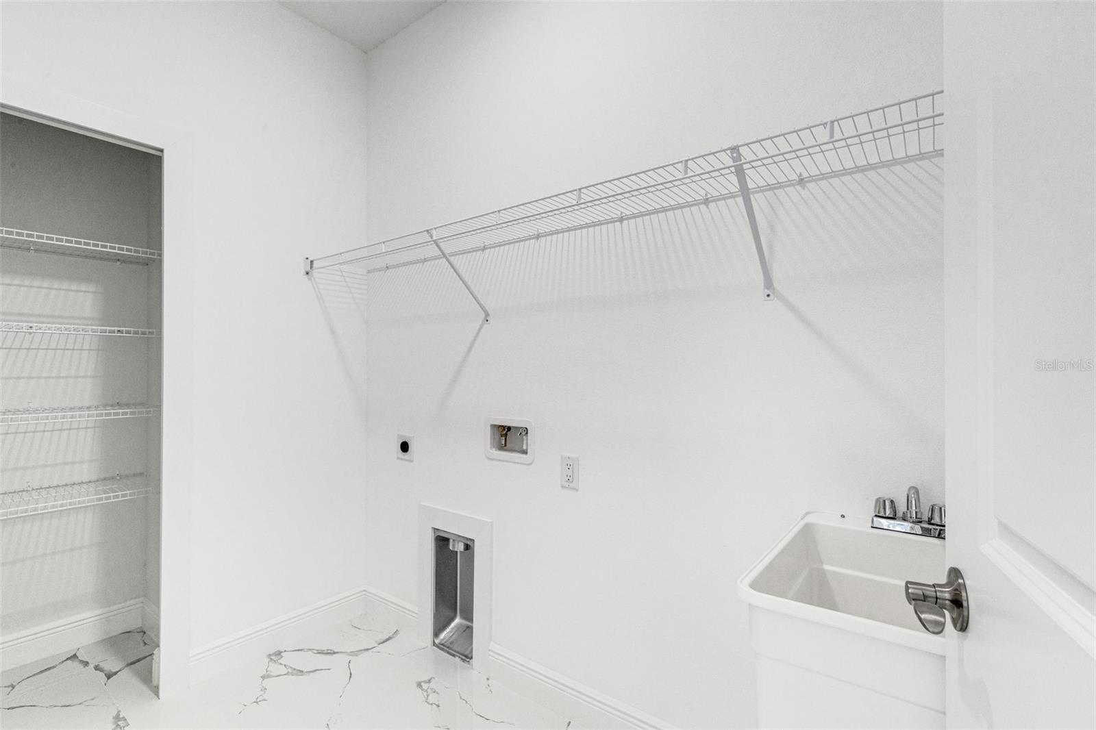 Laundry room with linen closet