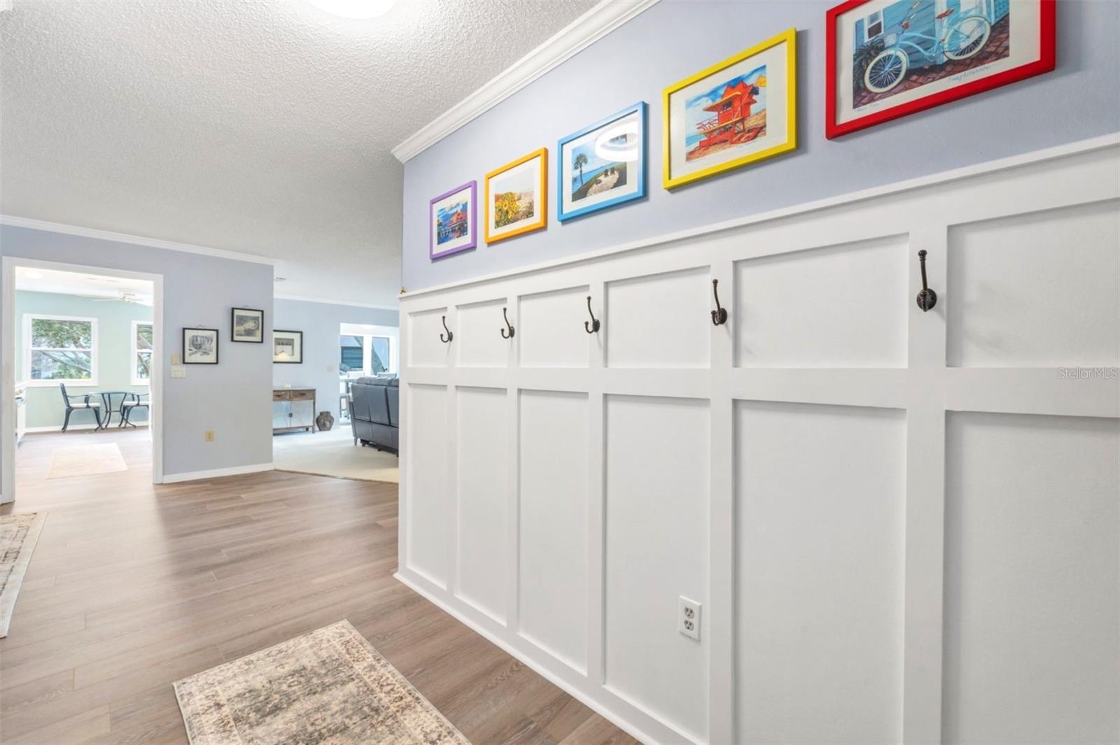 Entry foyer with custom millwork and new vinyl plank flooring.