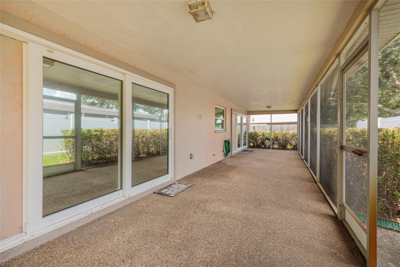Rear porch screened with sliders to living room and dining room