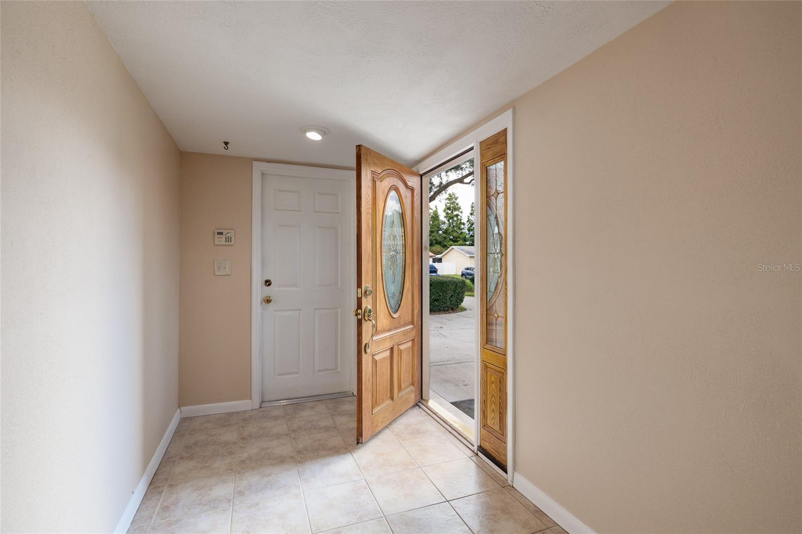 Living room to foyer and access to garage and front entrance