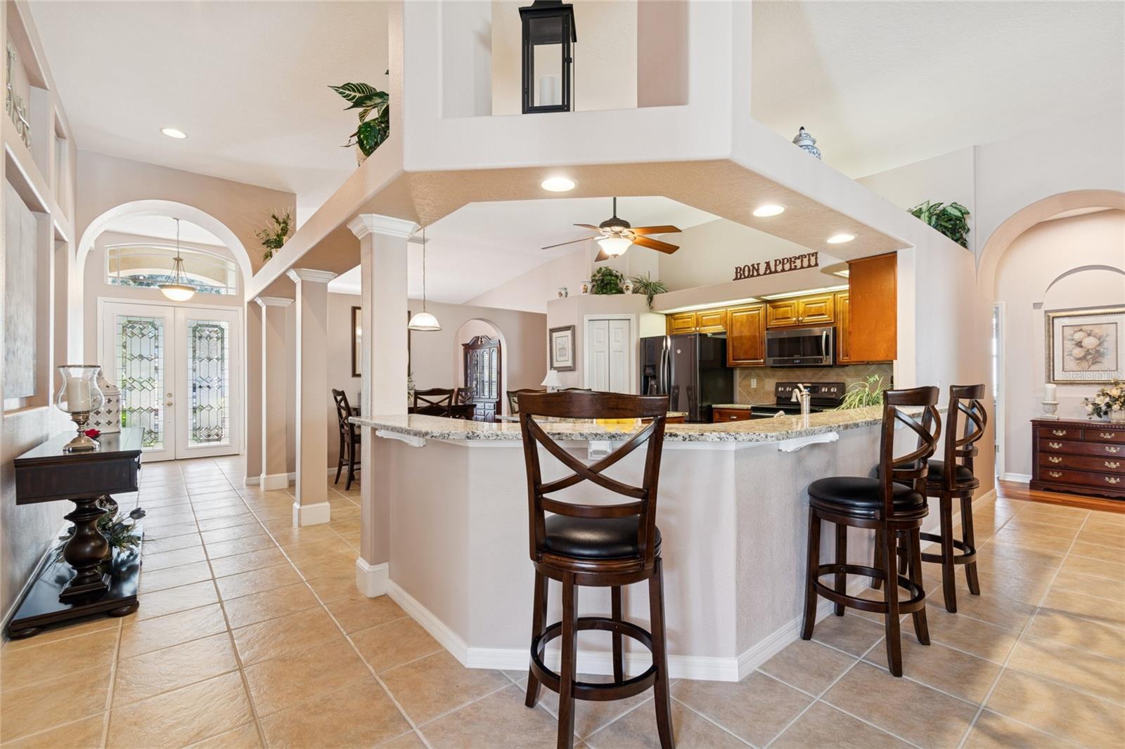 VIEW OF KITCHEN, HALLWAY AND FOYER