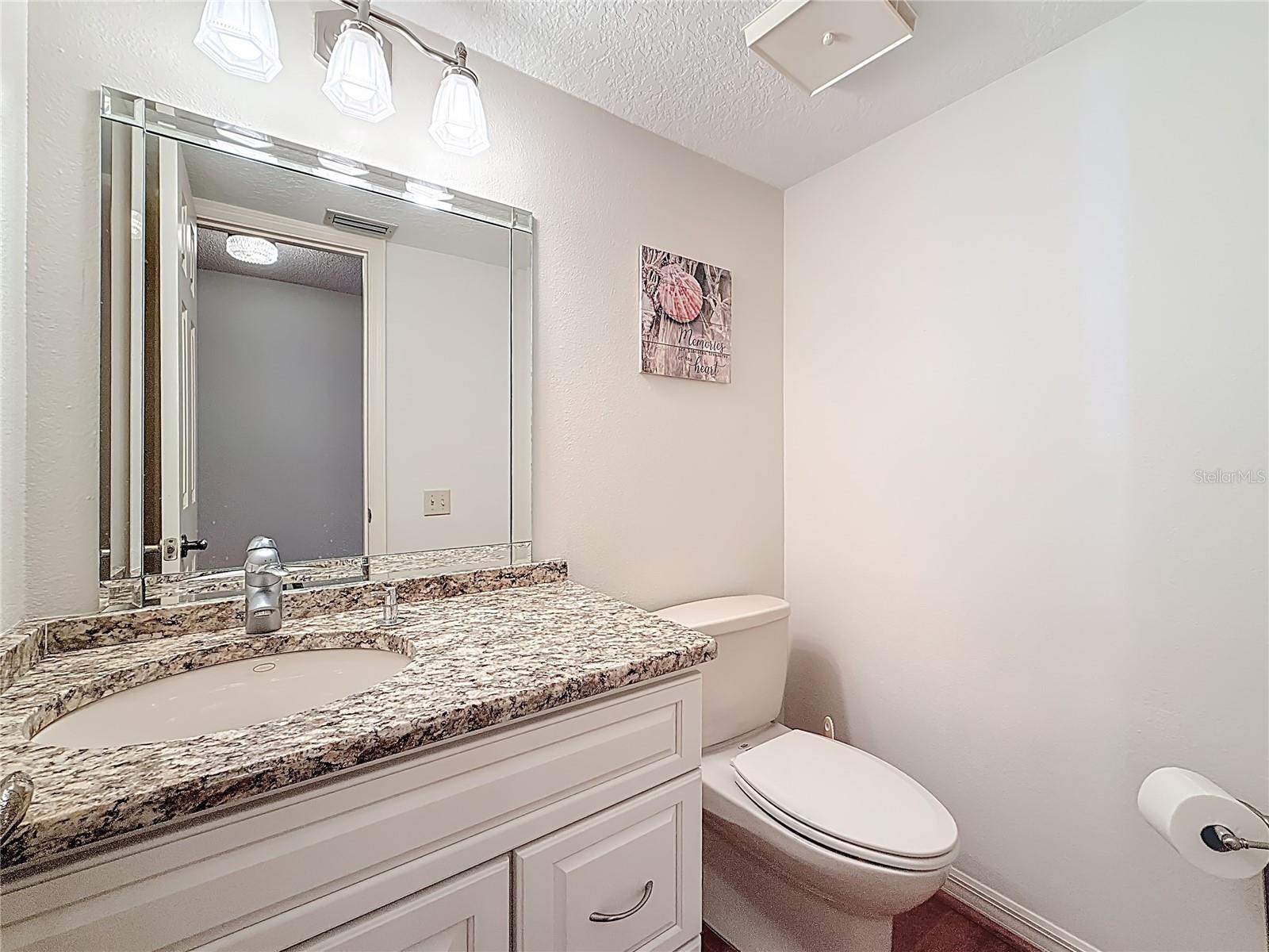 Updated half bath off the entry foyer - perfect for guests