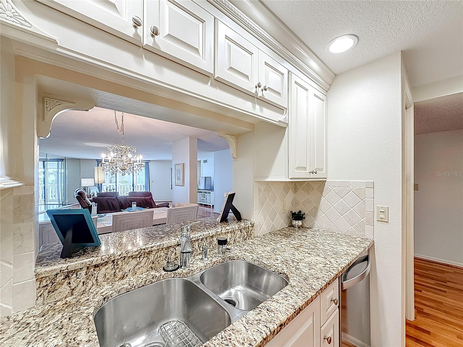 This shows a closer look at the opening that looks out from the kitchen to the dining and living room area