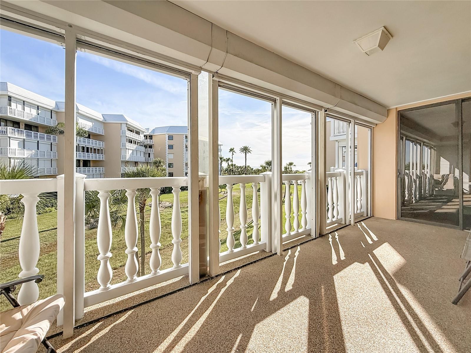 This shows the spacious balcony this unit has.  Notice that there are hurricane shutters across the entire balcony.