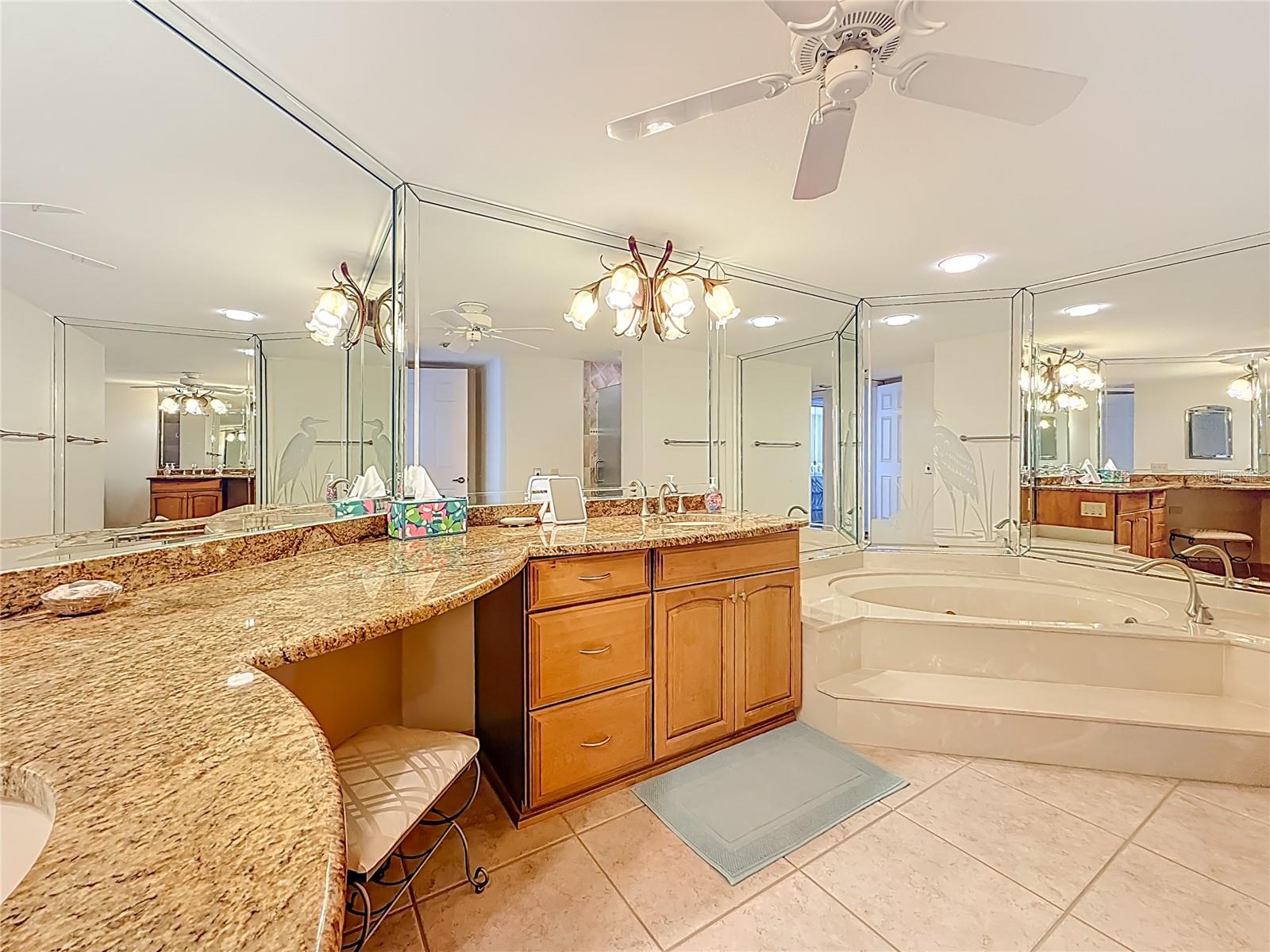 The primary bathroom has a jetted tub with a separate walk-in shower