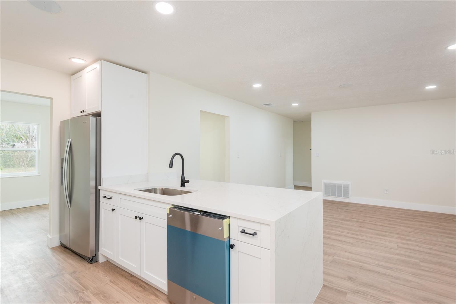 Kitchen over looking living room.