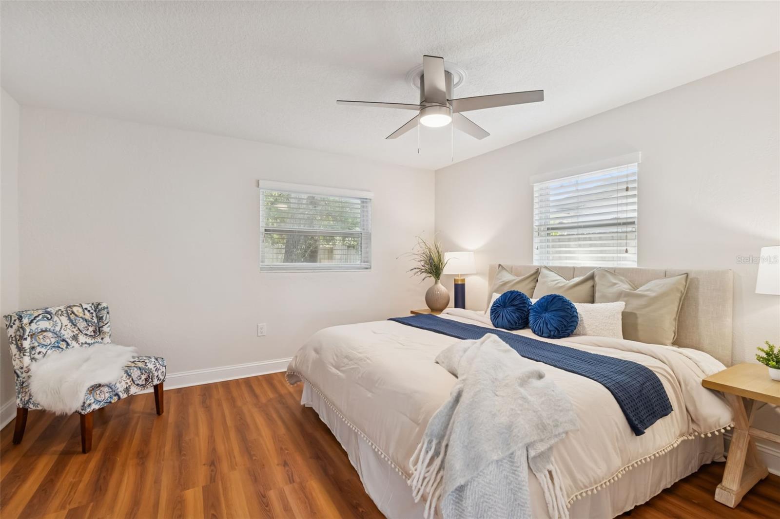 The primary bedroom is spacious enough for a King size bed,  end tables and more!
