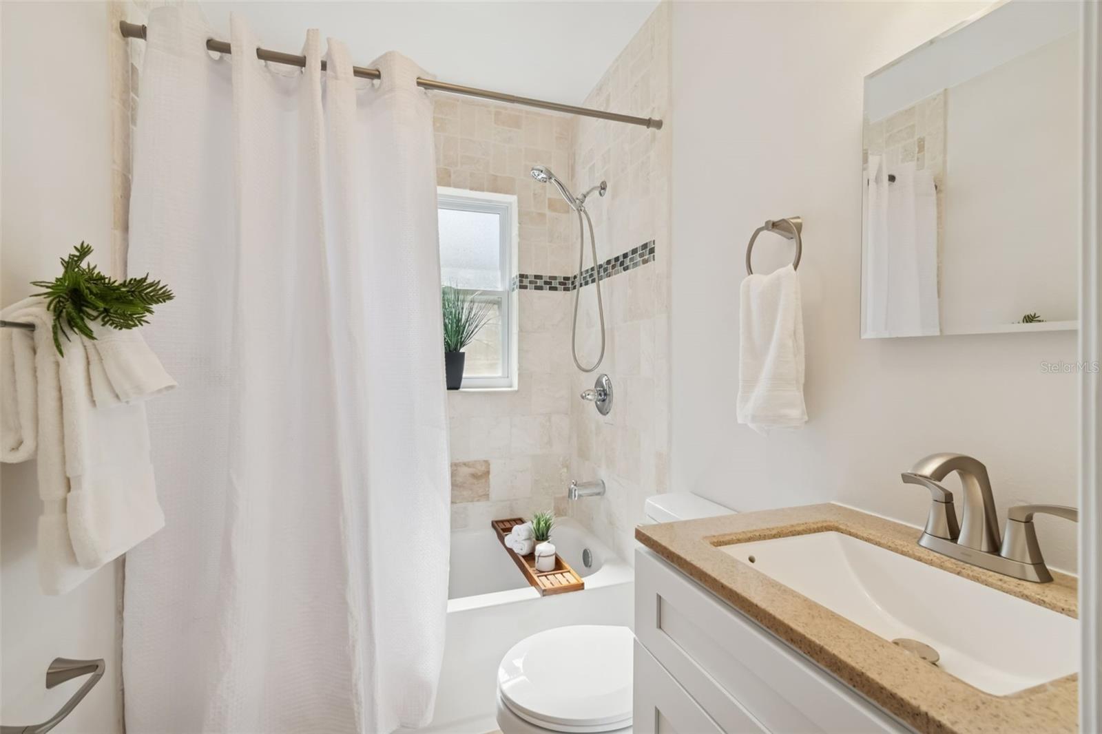 The primary bedroom has an en-suite bathroom that is beautifully remodeled.