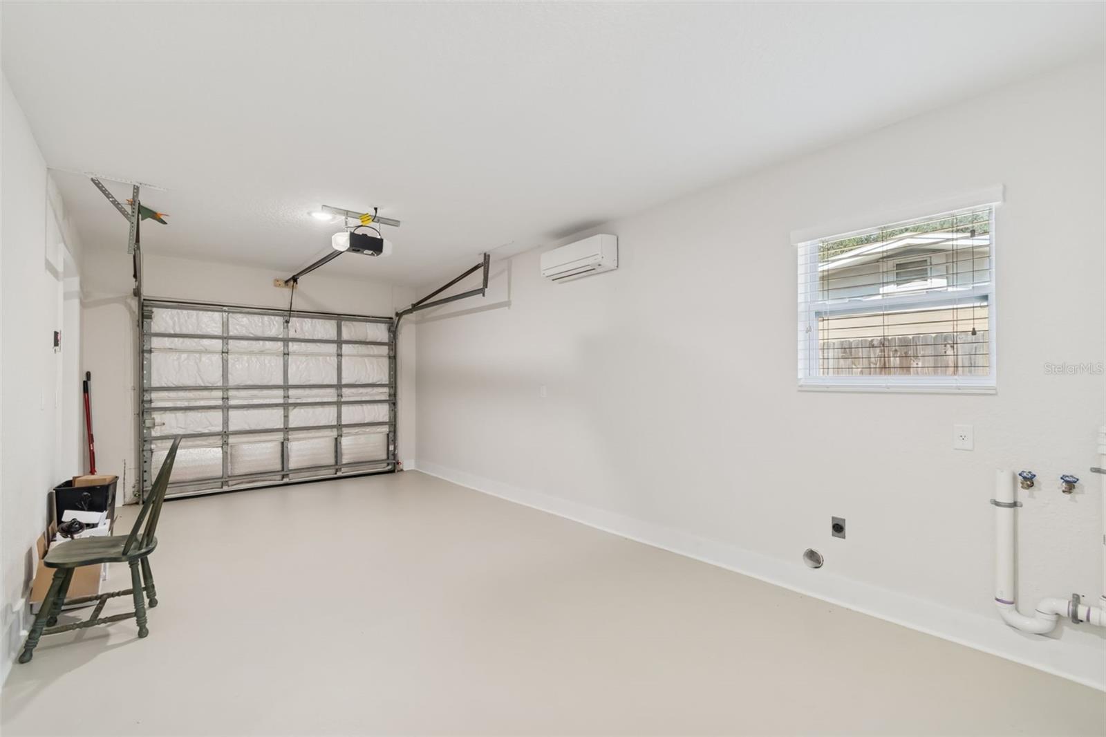 The oversized one car garage has a remote control and insulated door and is climate controlled with a split system for ac and heat.