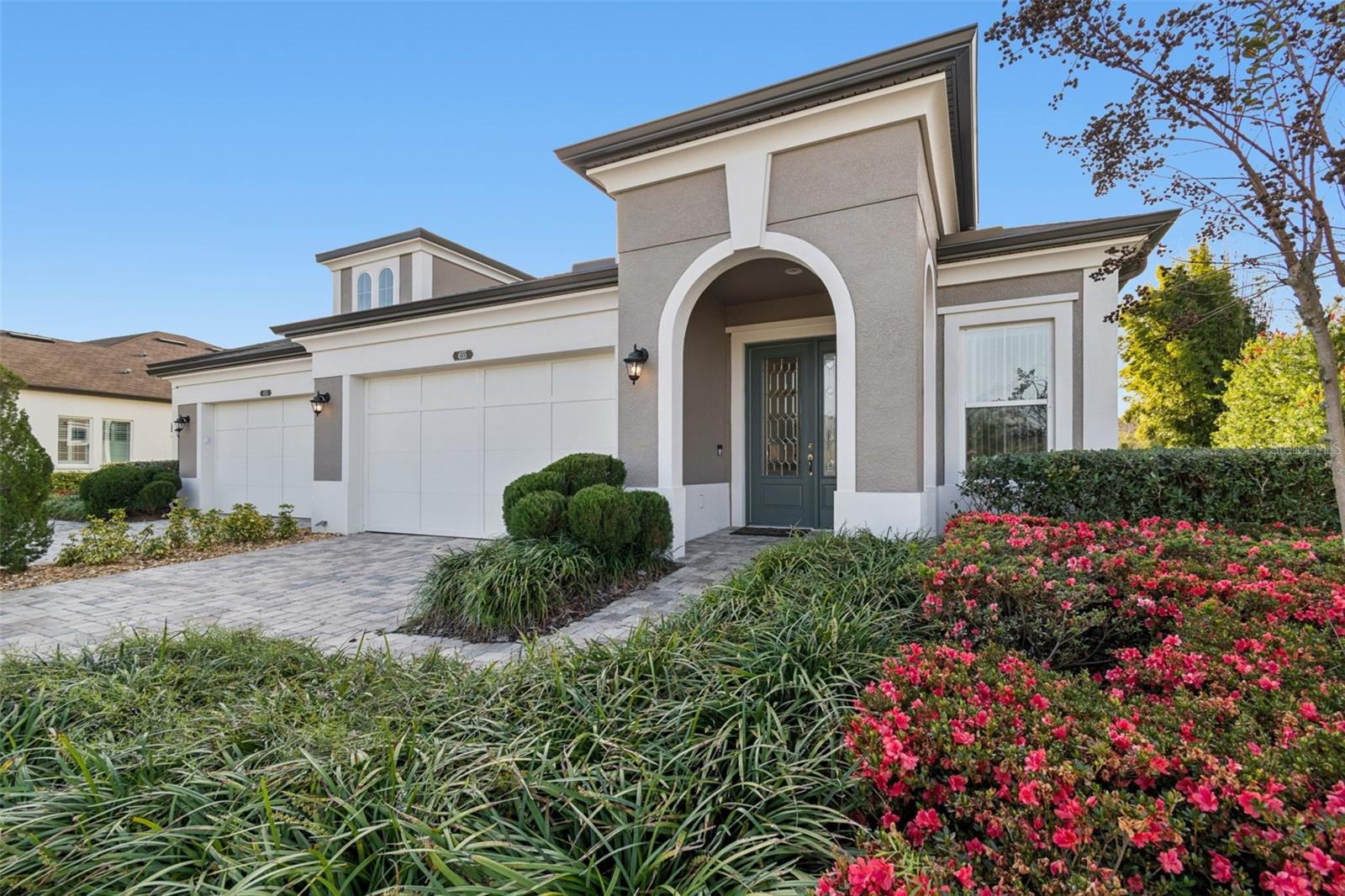 Inviting front elevation with pavered driveway and pristine curb appeal