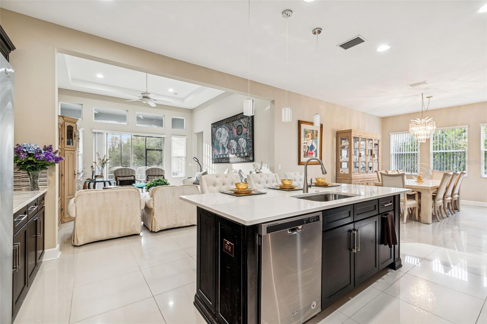 Well-appointed kitchen with quartz countertops, stainless steel appliances, and oversized island