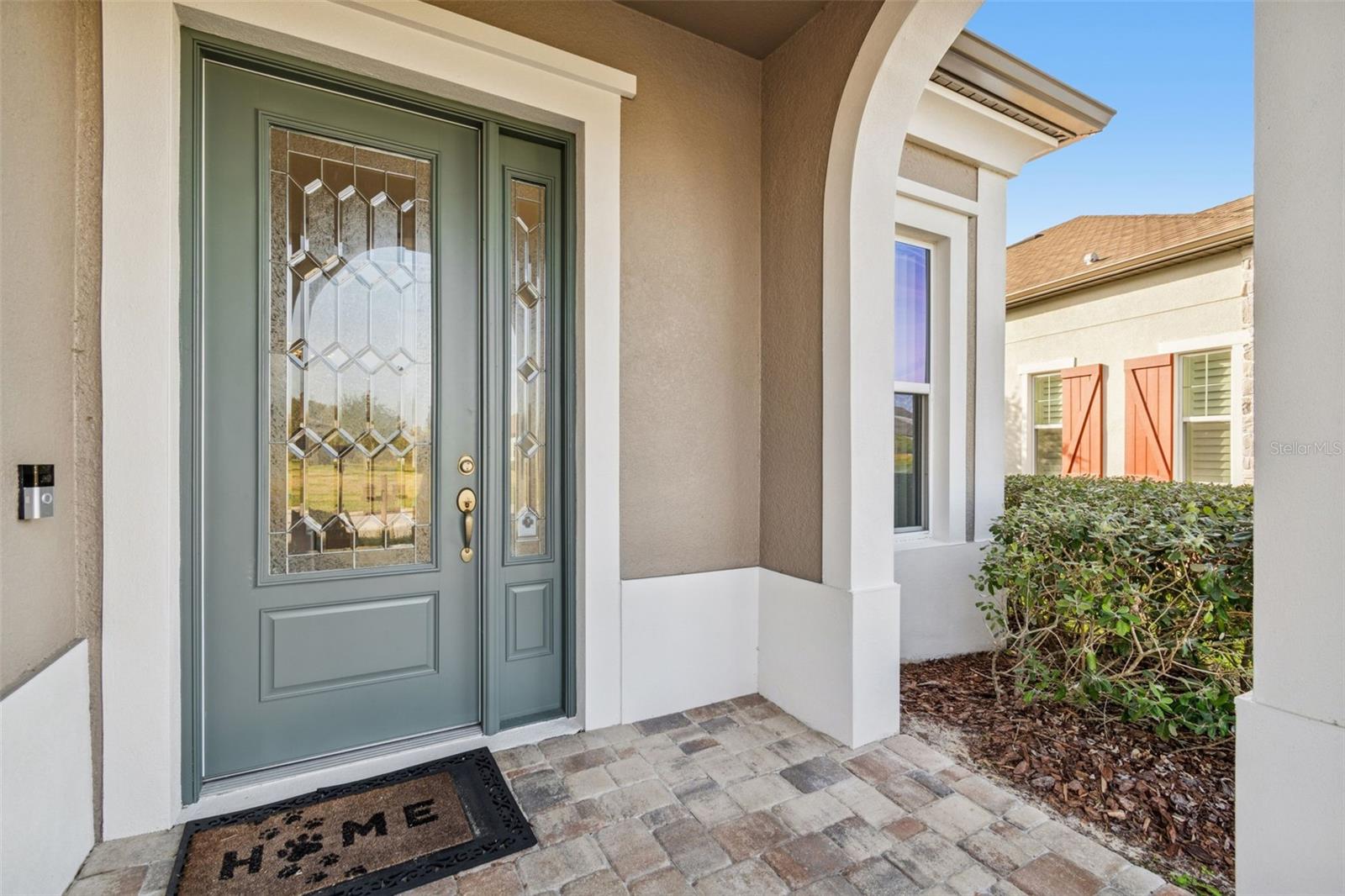 Elegant front entry featuring a decorative glass front door