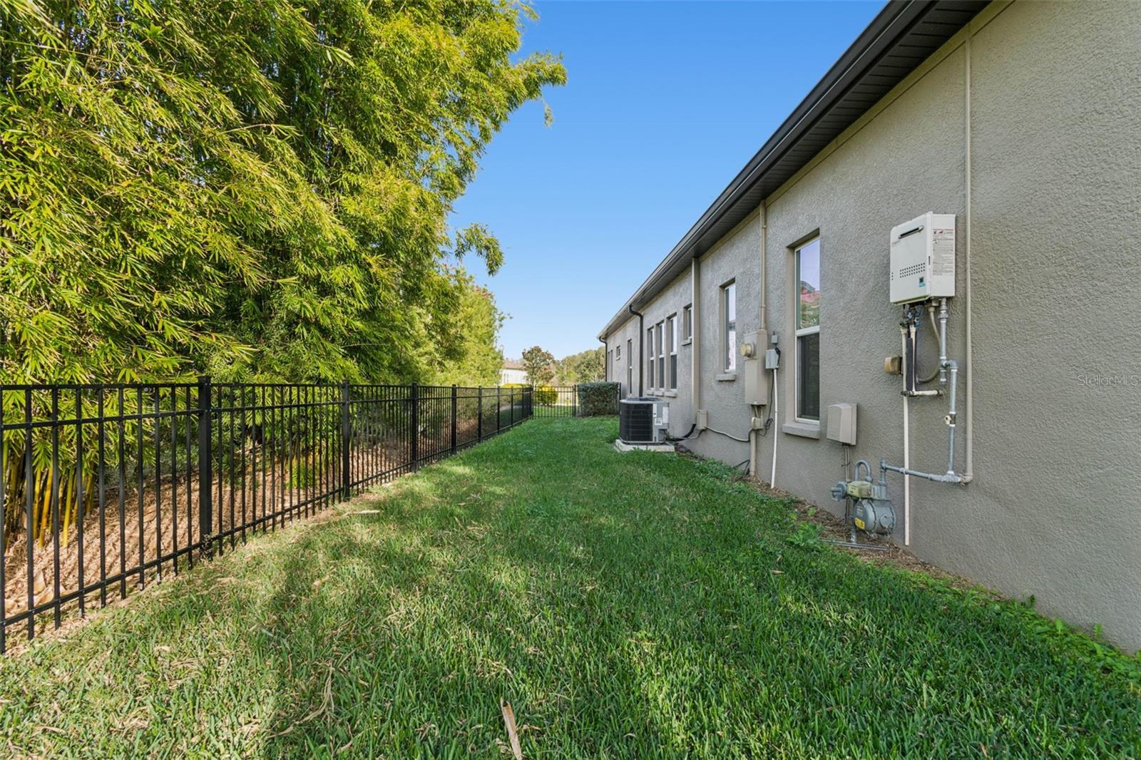 Private, fenced backyard with lush, manicured lawn