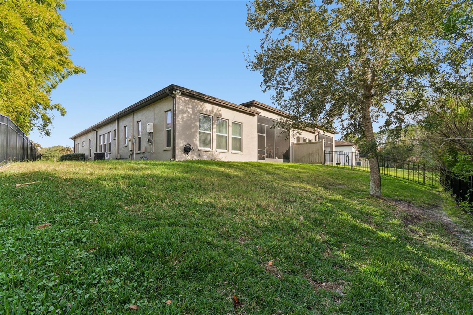 Private, fenced backyard with lush, manicured lawn