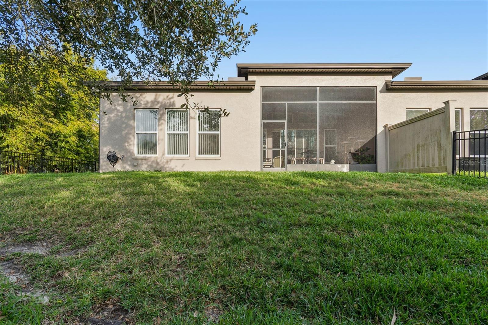 Private, fenced backyard with lush, manicured lawn