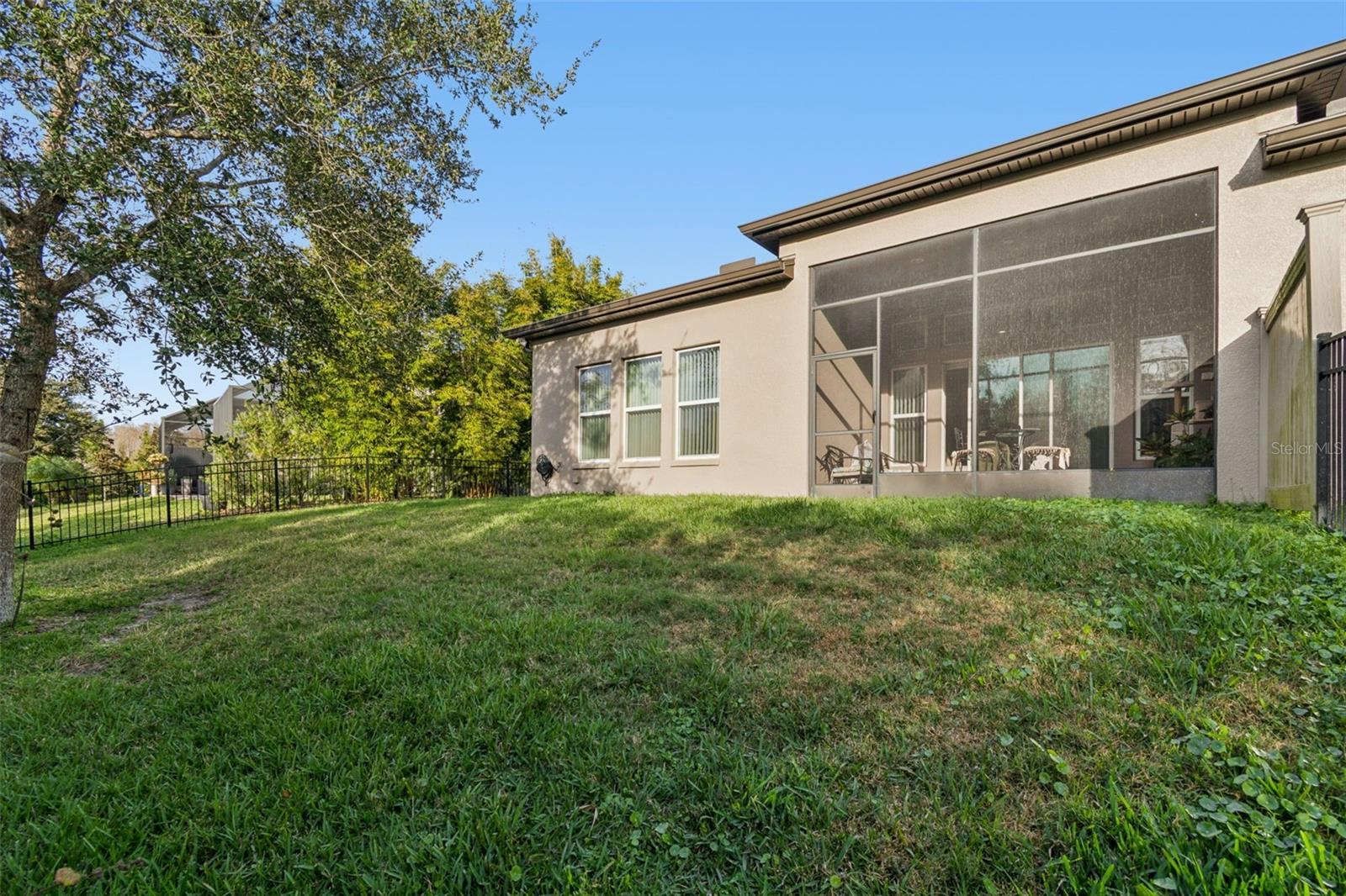 Private, fenced backyard with lush, manicured lawn