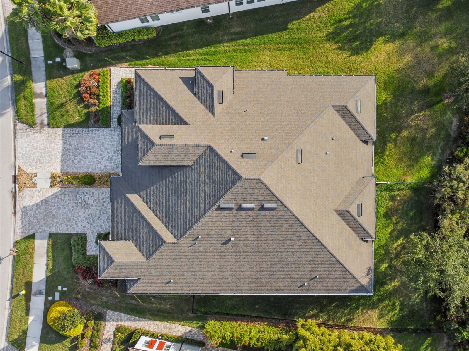 Aerial view highlighting the home’s footprint and setting