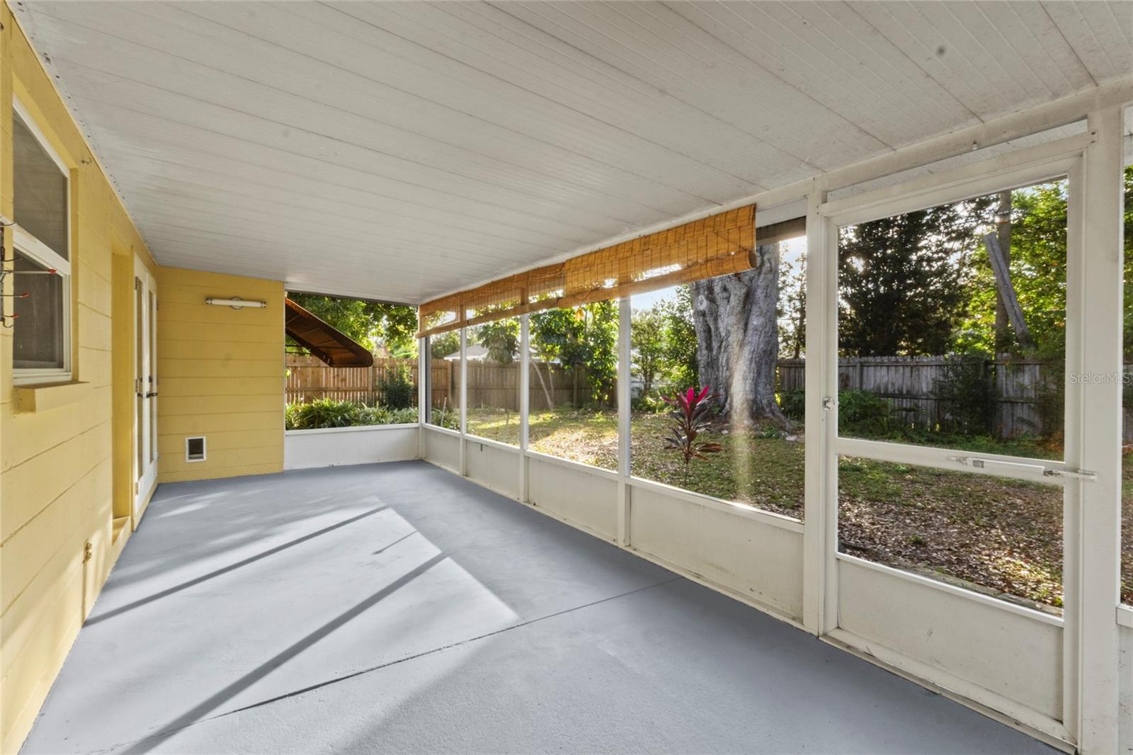 Cozy outdoor living space ideal for relaxing or enjoying Florida evenings bug-free.