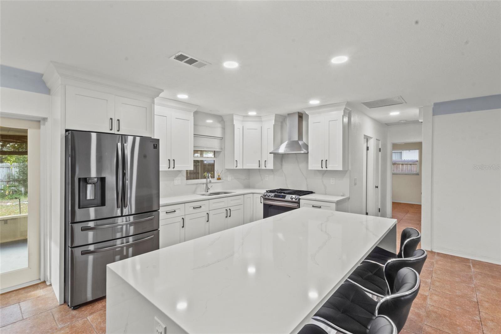 Generous island seating opens to the main living area, perfect for casual dining and hosting guests.