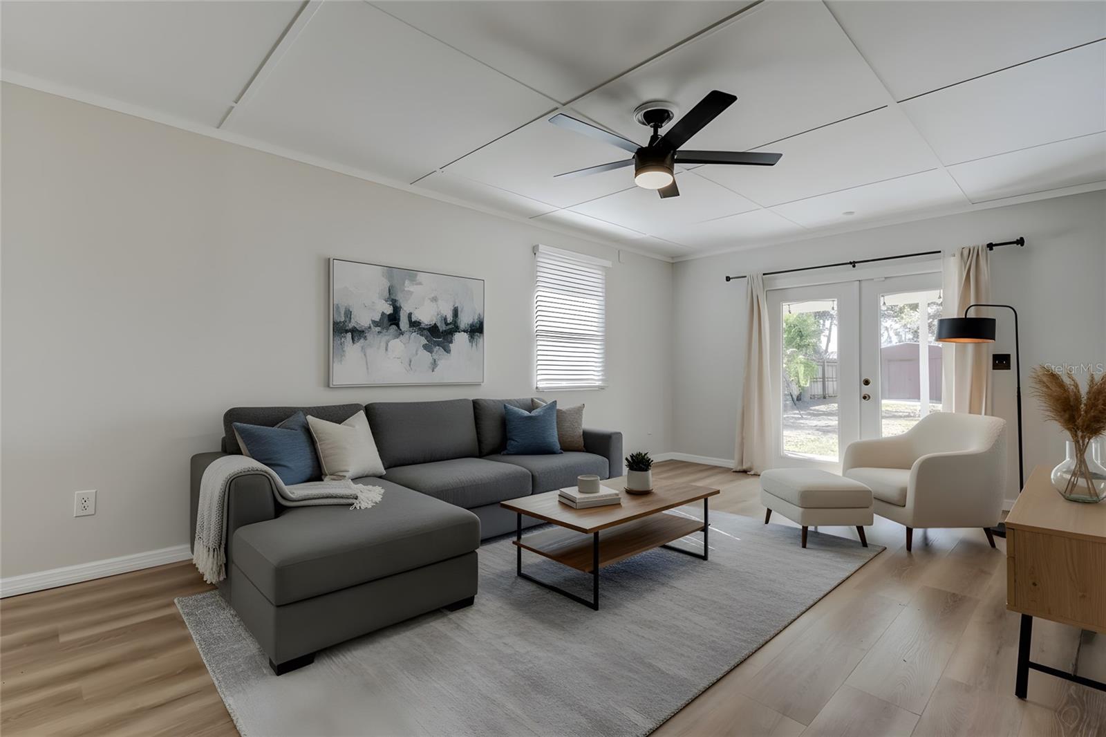 Family room with French doors to backyard and outdoor patio