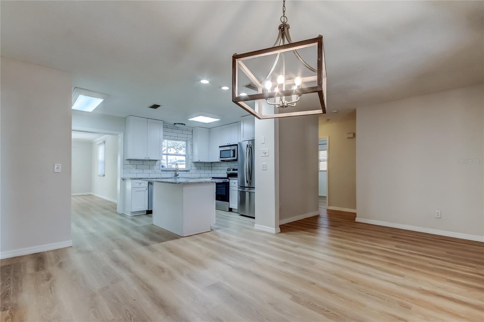 View from dining to kitchen and guest bedrooms