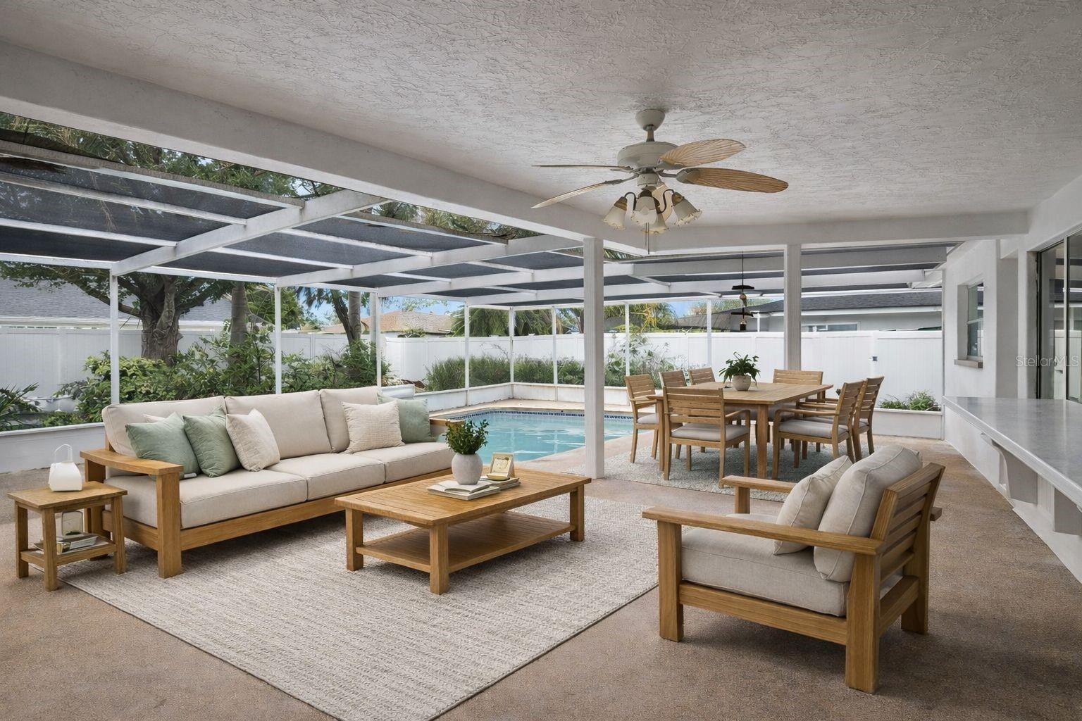 Covered lanie with passthru to the kitchen and covered for all weather entertaning