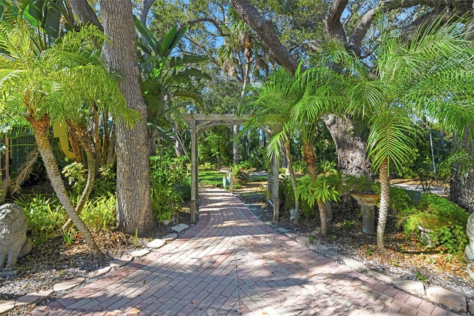 Paver walkway surrounded by lush landscaping