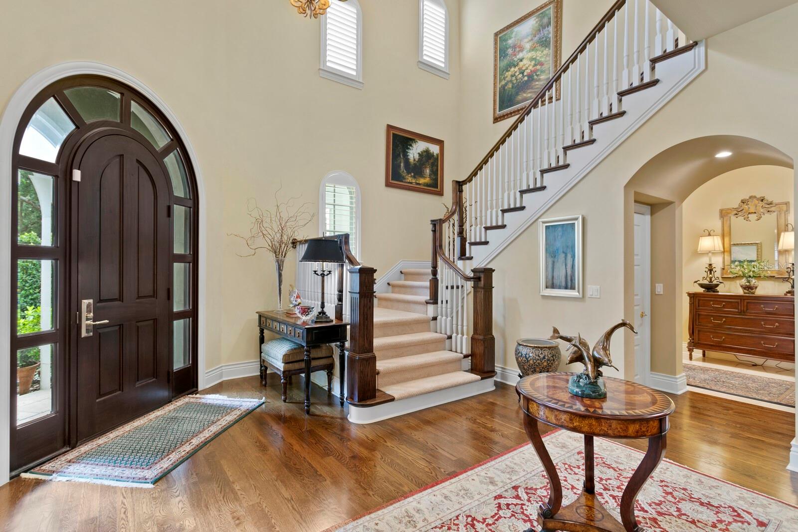 Entry with impressive custom door, and stairway