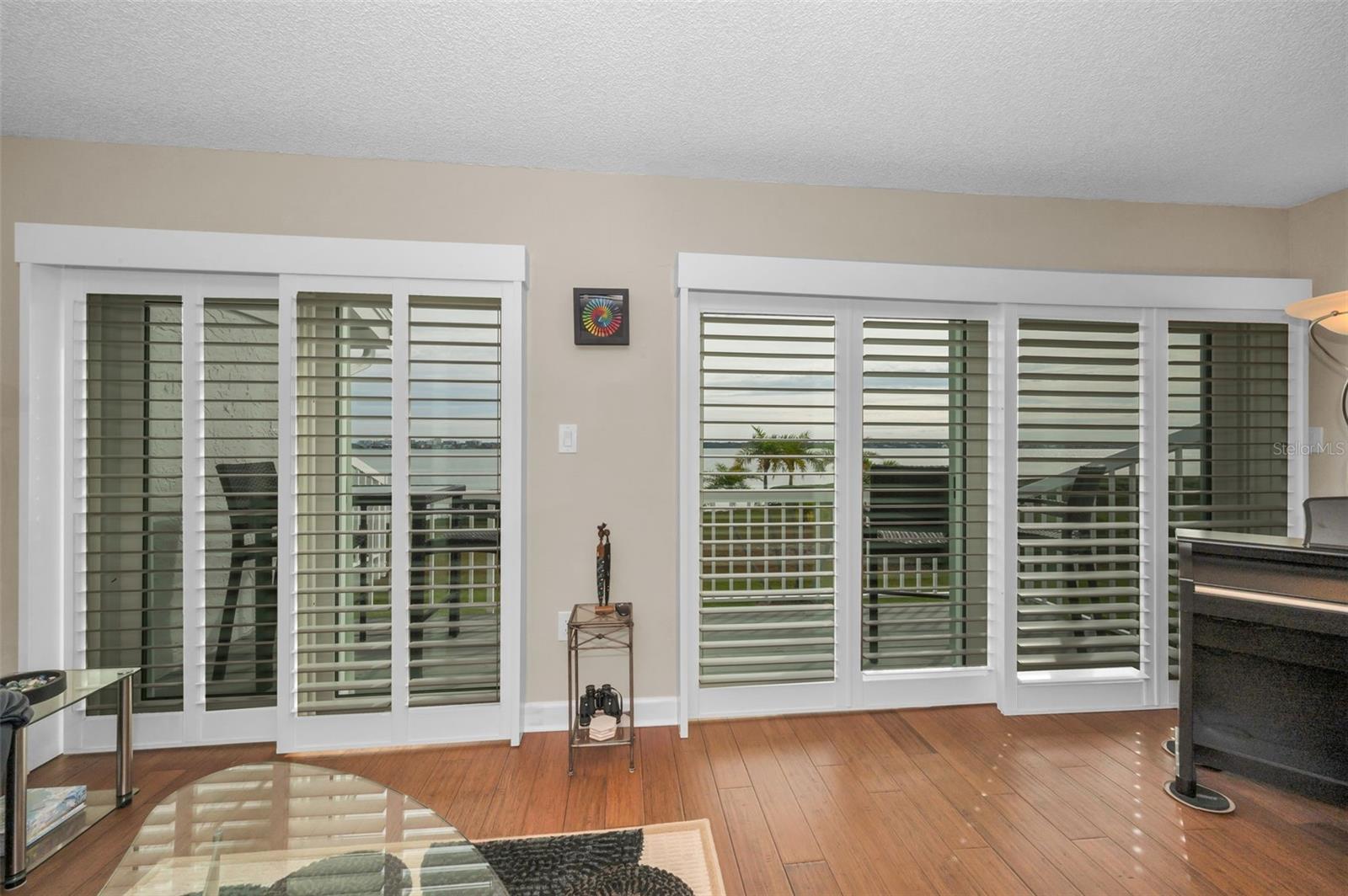 New sliding glass doors leading to the waterfront balcony