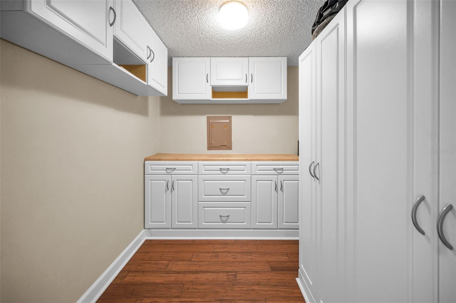 Main level Utility Room with extra cabinets and storage