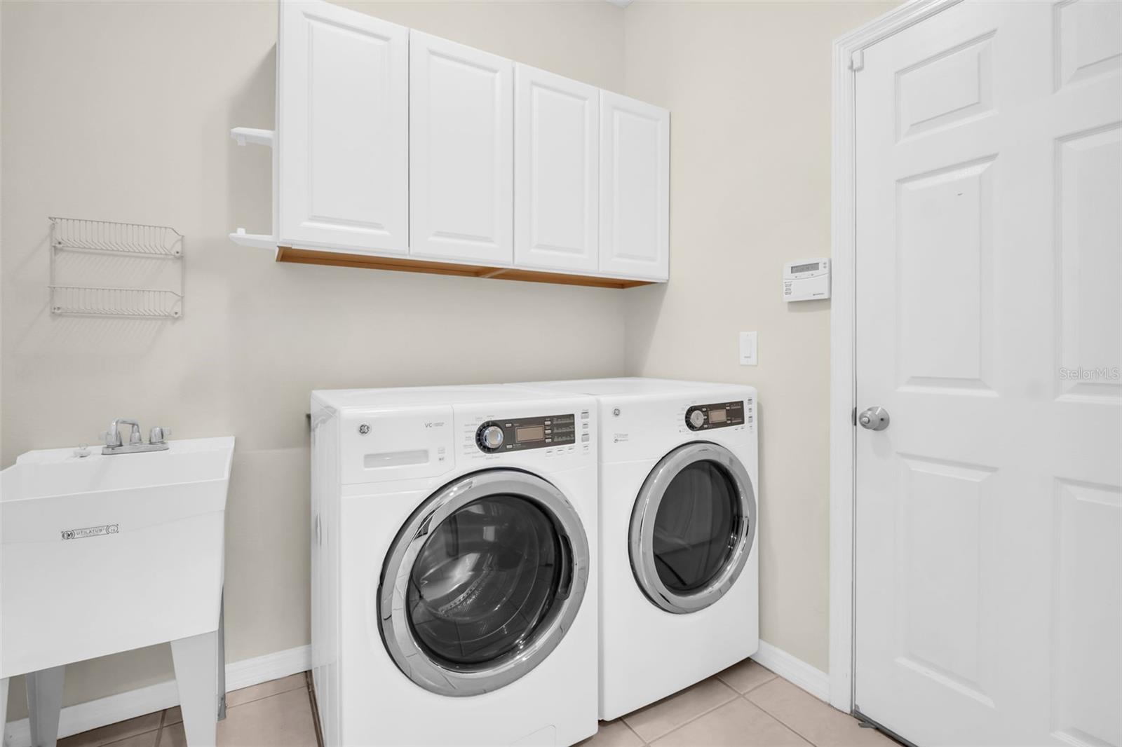 Fabulous laundry room with additional cabinetry & utility sink~