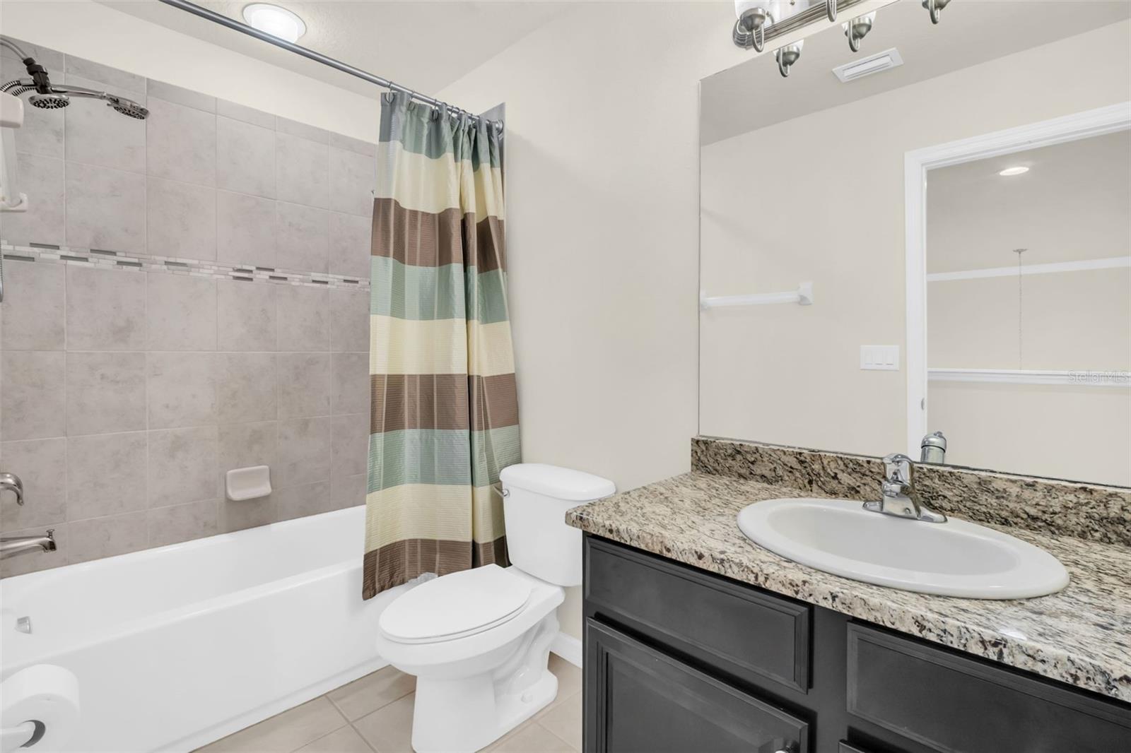 Upstairs hall bath with granite countertops, tub/shower combo and tucked between 2nd & 3rd bedrooms~