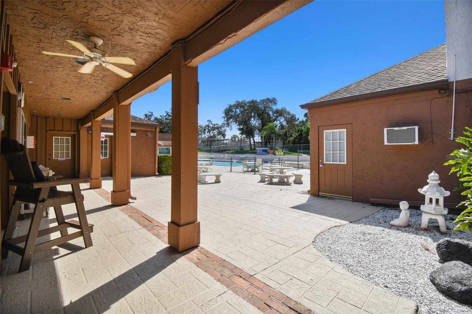 pool area with mens and women's separate lockers restrooms and indoor shower and changing area benches..