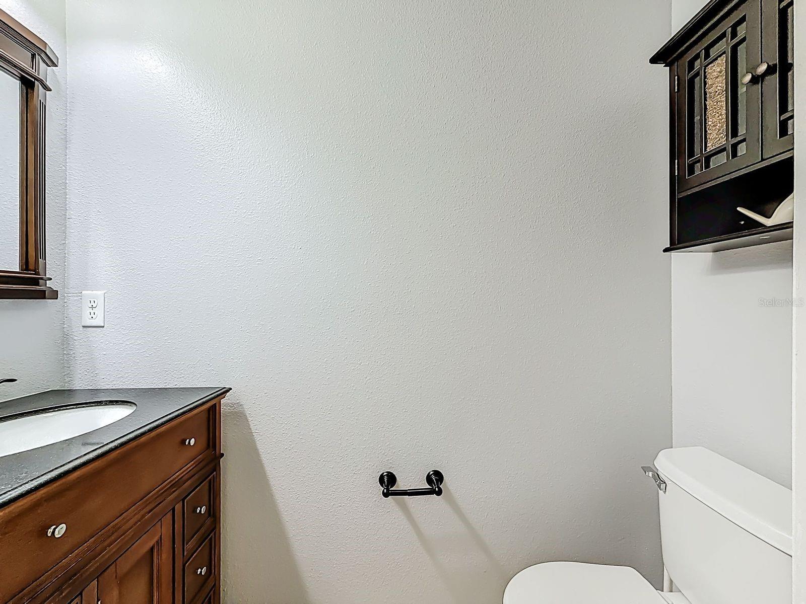 Half Bath with new fixtures and vanity with granite top